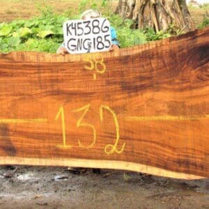Wooden slab with numbers and small sign.