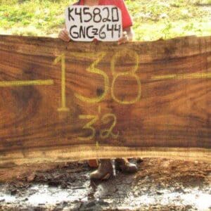 Large wooden slab with yellow markings.