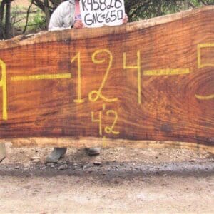 Large wooden slab with yellow painted numbers.