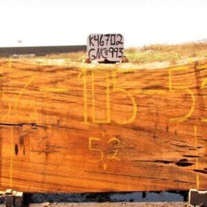 Large wooden slab with yellow markings.