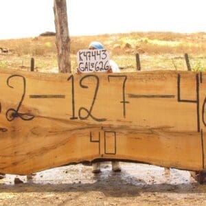 Large wooden slab with numbers and sign.